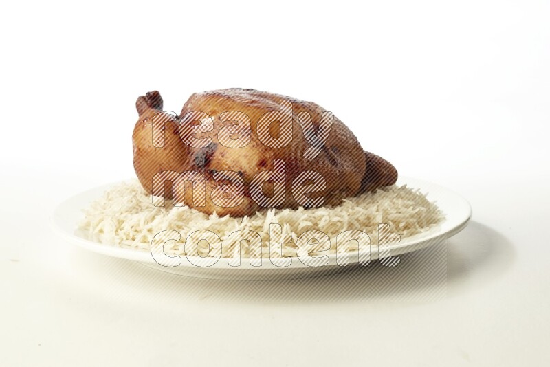 white  basmati Rice with  whole roasted chicken  on a white rounded plate direct on white background