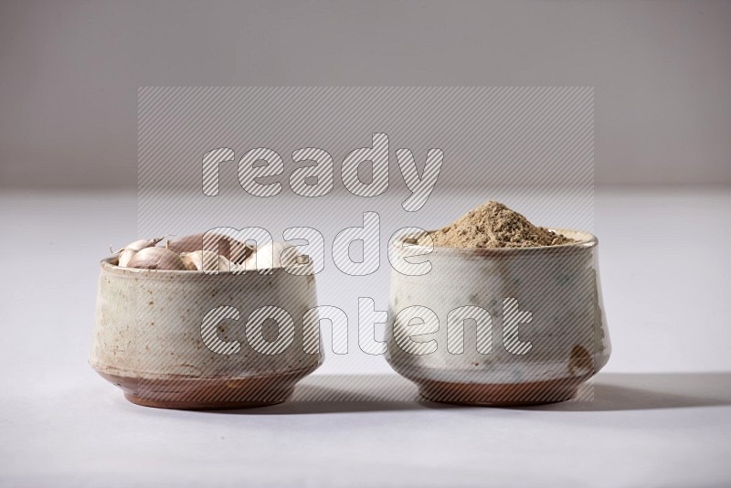 2 beige pottery bowls full of garlic powder and cloves on a white flooring in different angles