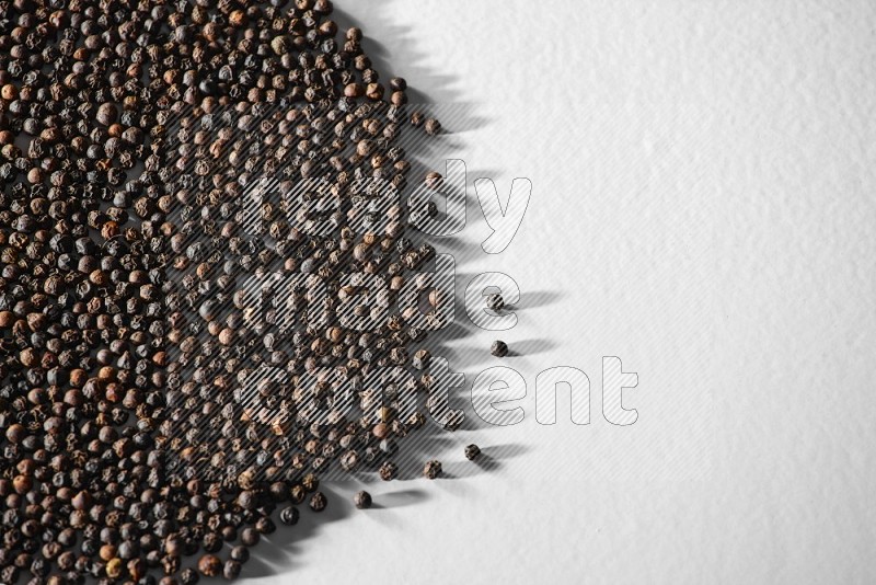 Black pepper on a white flooring