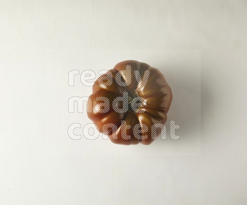 Single topview Heirloom tomato on a white backgrounds