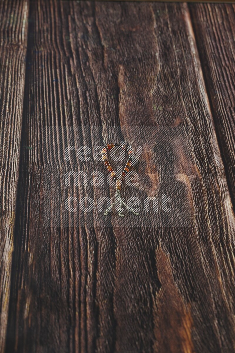 A prayer beads placed on wooden background