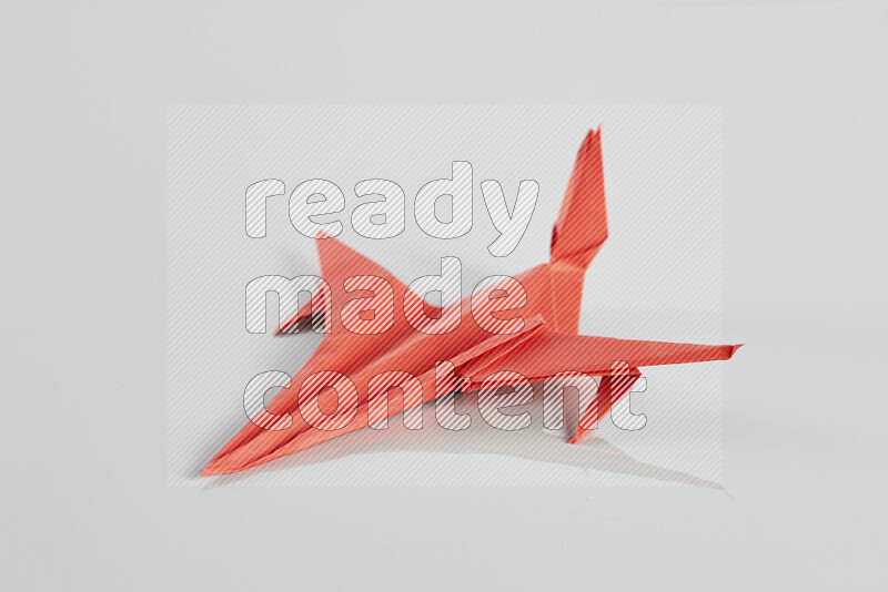 Origami plane on grey background