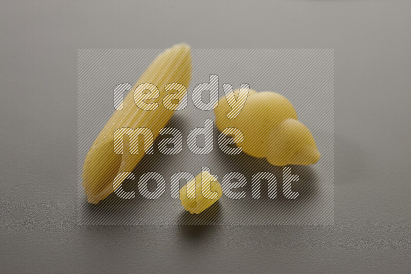 Different pasta types on grey background