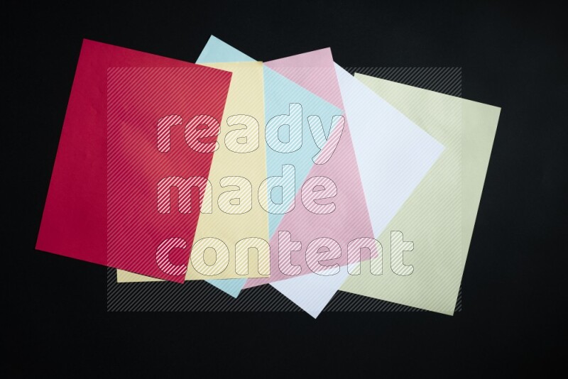 Multicolored paper sheet on black background