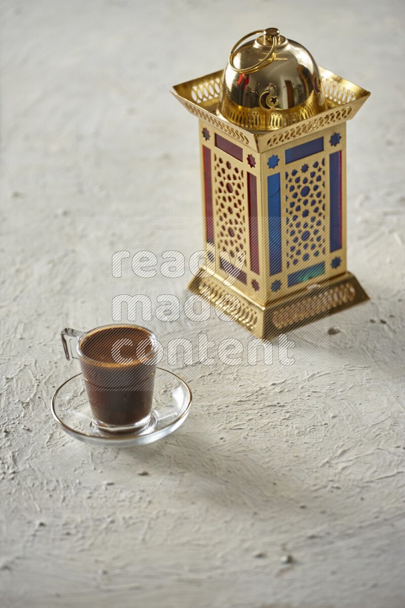 A golden lantern with different drinks, dates, nuts, prayer beads and quran on textured white background