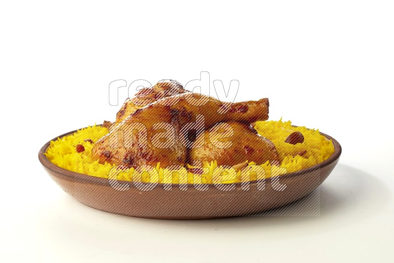 yellow basmati Rice with kabsa chicken pieces on a pottery plate direct on white background
