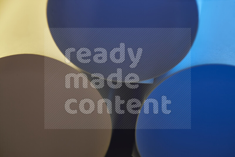 The image shows an abstract paper art with circular shapes in varying shades of blue and warm tones