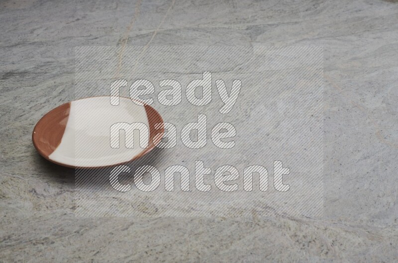 Multicolored Pottery Plate On Grey Marble Flooring