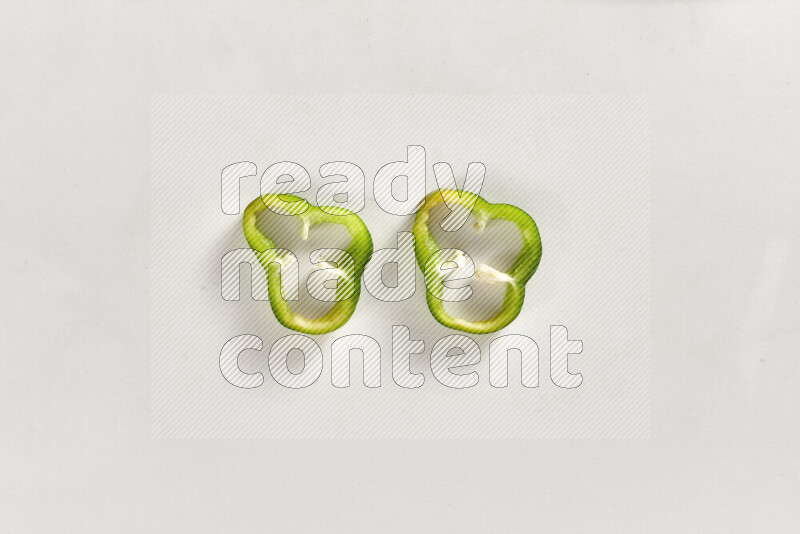 Green bell pepper slices on white background