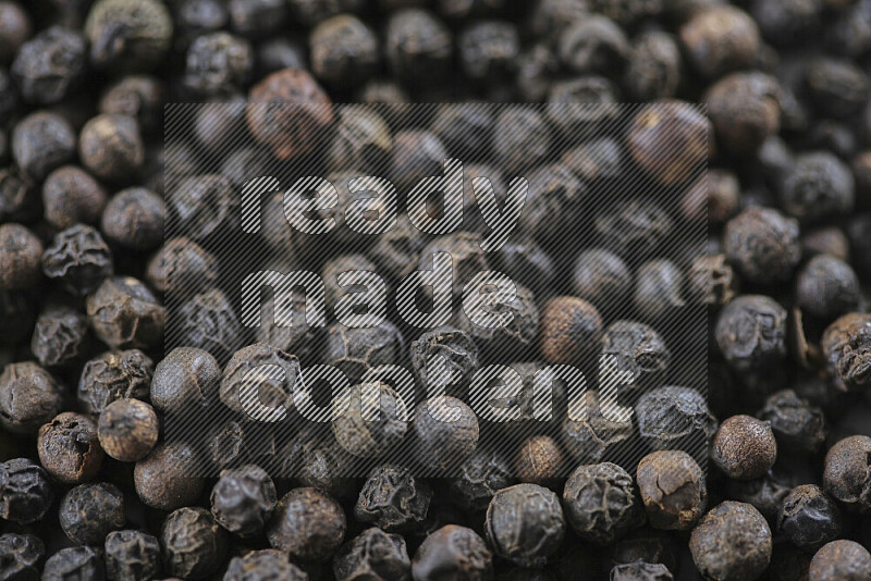 Black pepper beads on white background