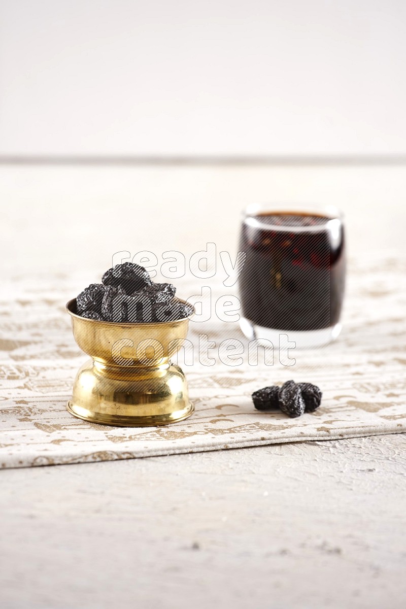 Dried fruits in a metal bowl with tamarind in a light setup