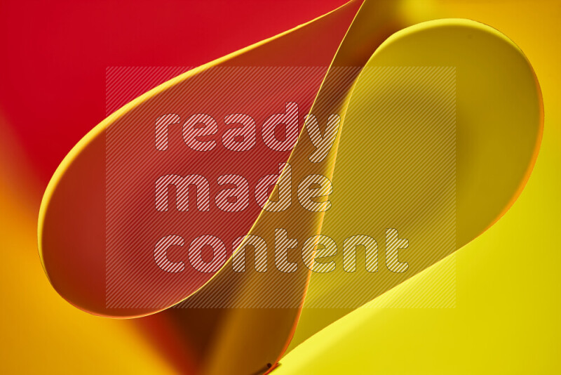 An abstract art of paper folded into smooth curves in yellow and red gradients