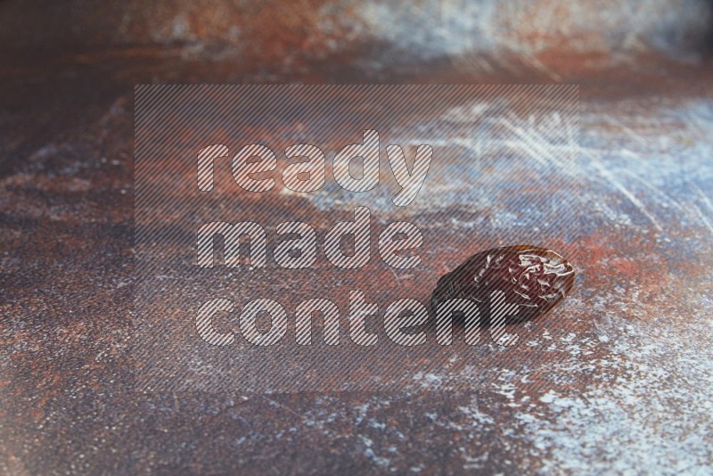 one madjoul date on a rustic reddish background