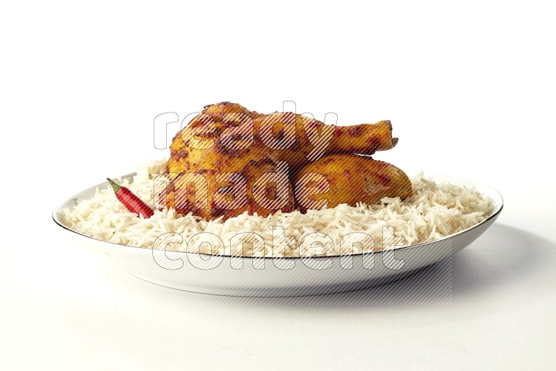 white basmati Rice with kabsa chicken pieces on a white plate with a silver rim direct on white background