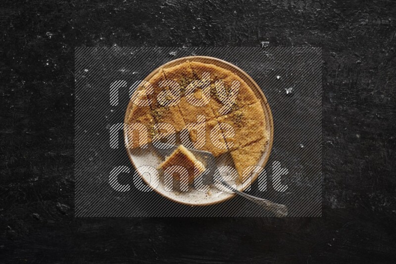 Konafa in different plates in a dark setup