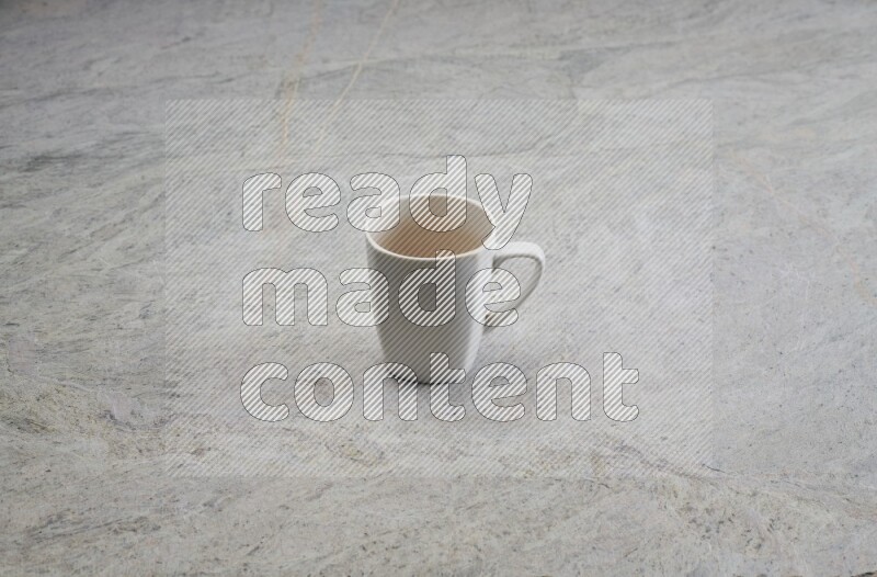 A white ceramic mug on grey marble background