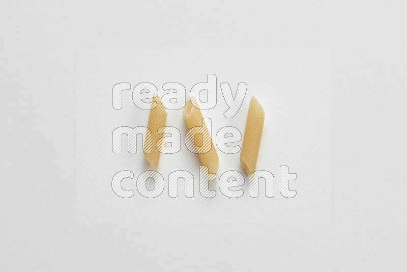 Mini penne pasta on white background