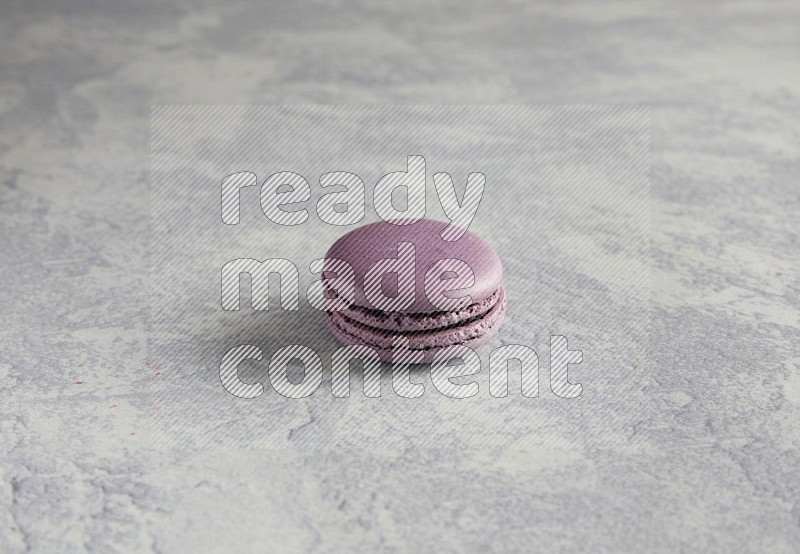 45º Shot of Purple Blueberry macaron on white  marble background