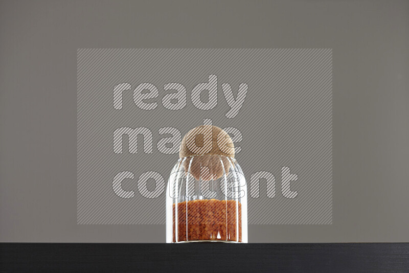 Lentils in a glass jar on black background