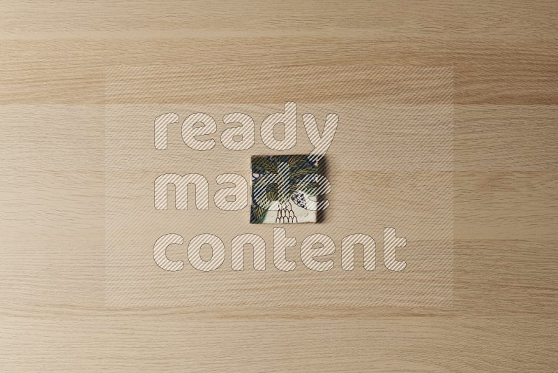 Top view shot of a pottery coaster\ tile on oak wooden flooring