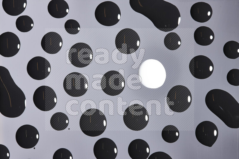 Close-ups of abstract white and black paint droplets on the surface