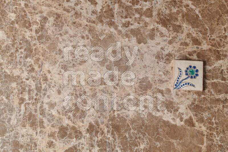 A decorative coaster on beige marble background