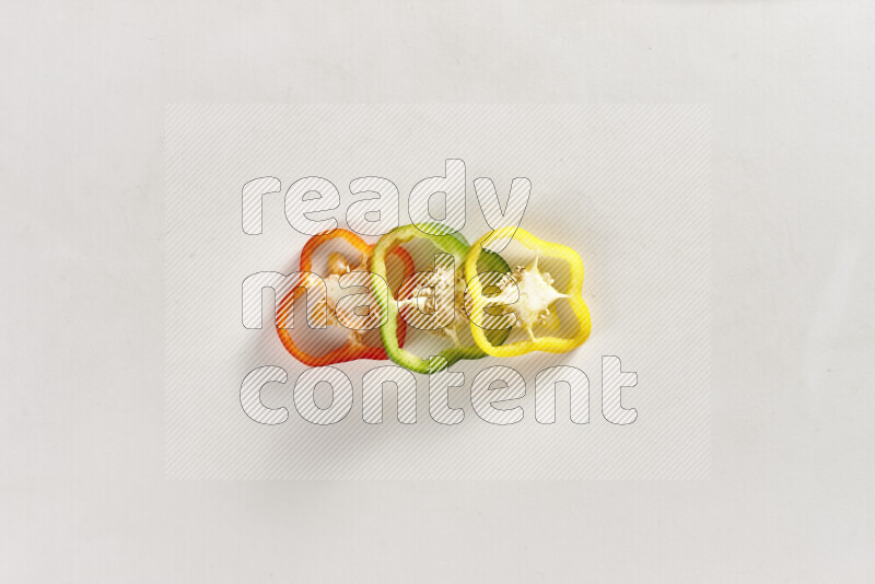 Assorted bell pepper slices on white background