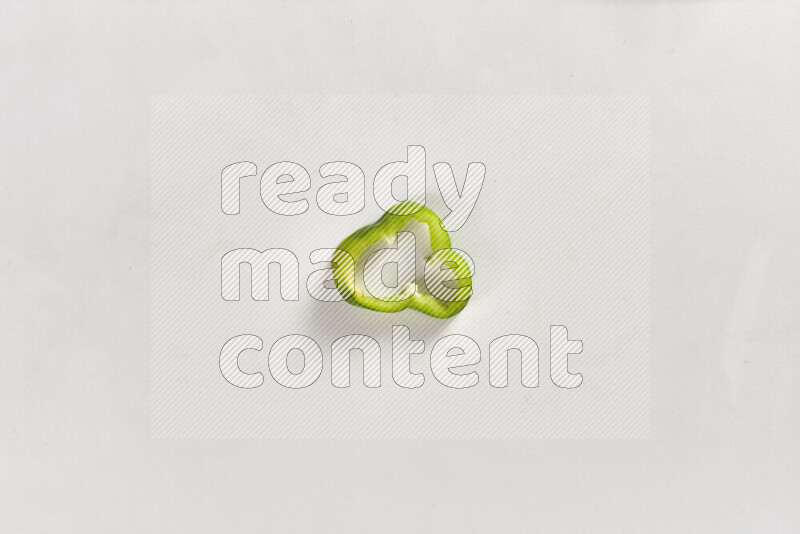 Green bell pepper slices on white background