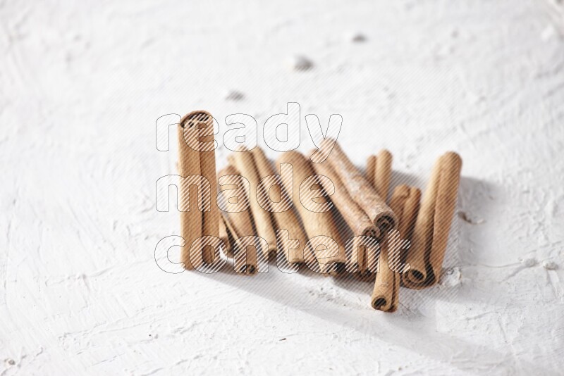 Cinnamon sticks on a textured white background