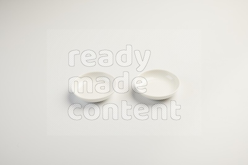 white ceramic round sauce dish on white countertop