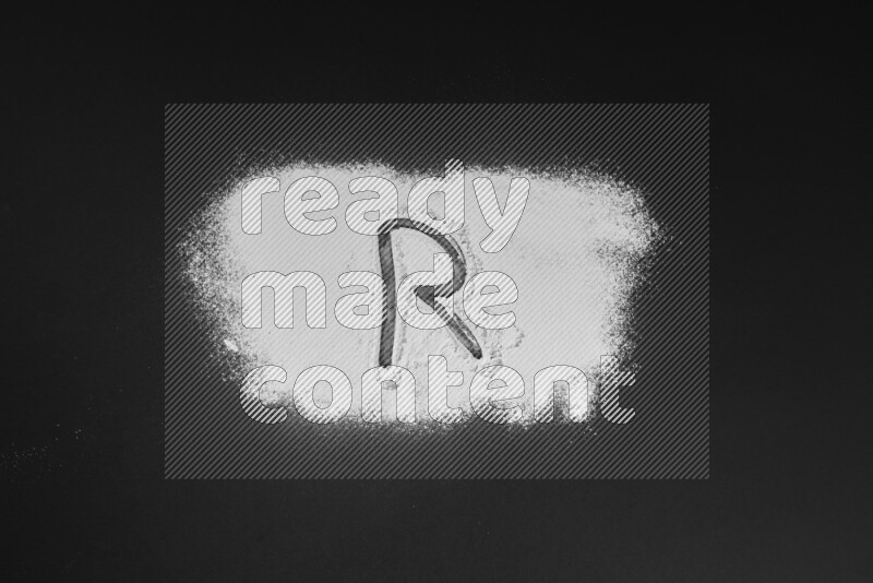 Alphabets written with powder on black background