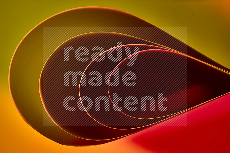 An abstract art of paper folded into smooth curves in yellow, brown and red gradients