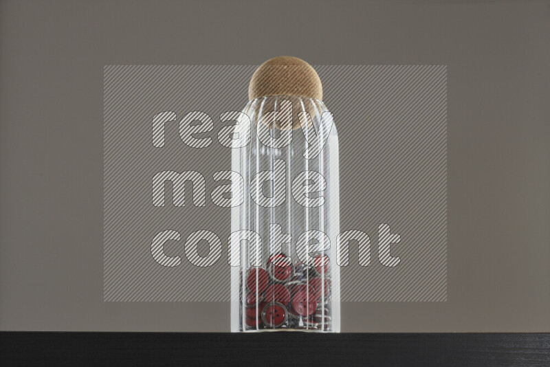 Buttons in a glass jar on black background