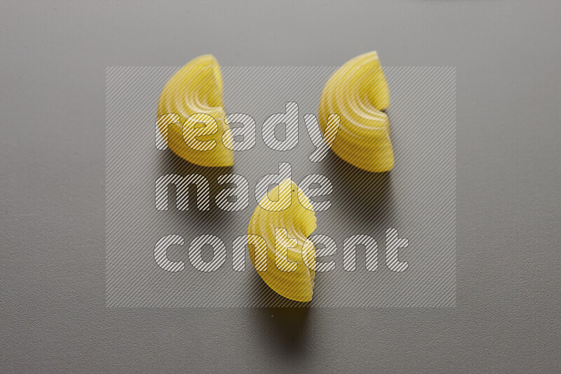 Elbow pasta on grey background