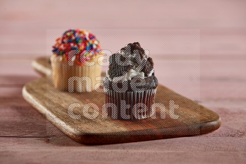 Chocolate mini cupcake topped with oreo on a wooden board