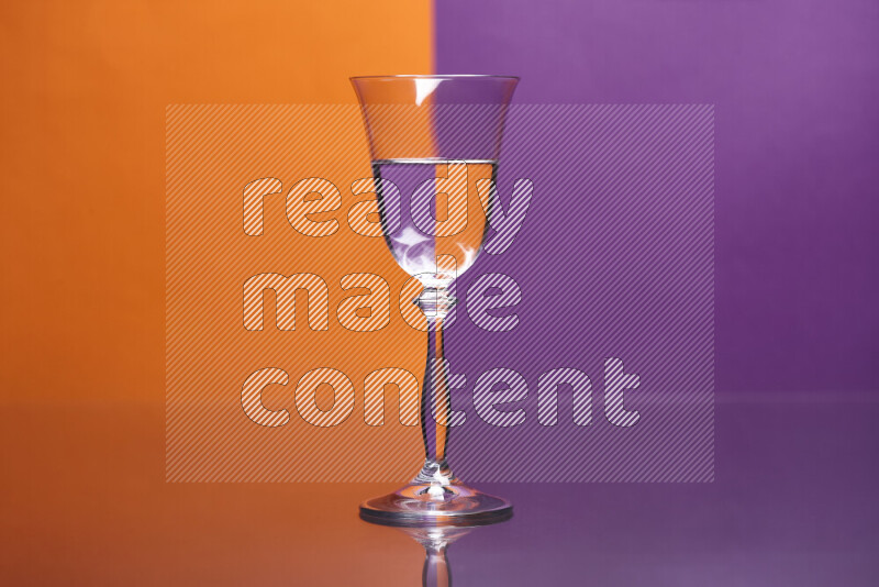 The image features a clear glassware filled with water, set against orange and purple background