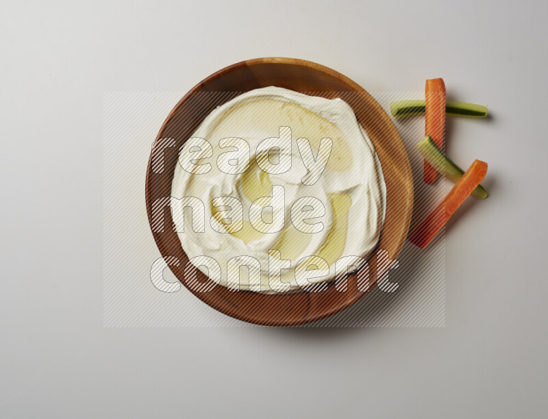 Lebnah garnished with olive oil in a wooden plate on a white background