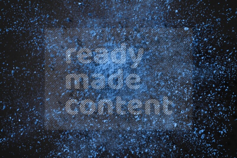 Blue powder explosion on black background