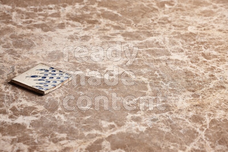 A decorative coaster on beige marble background