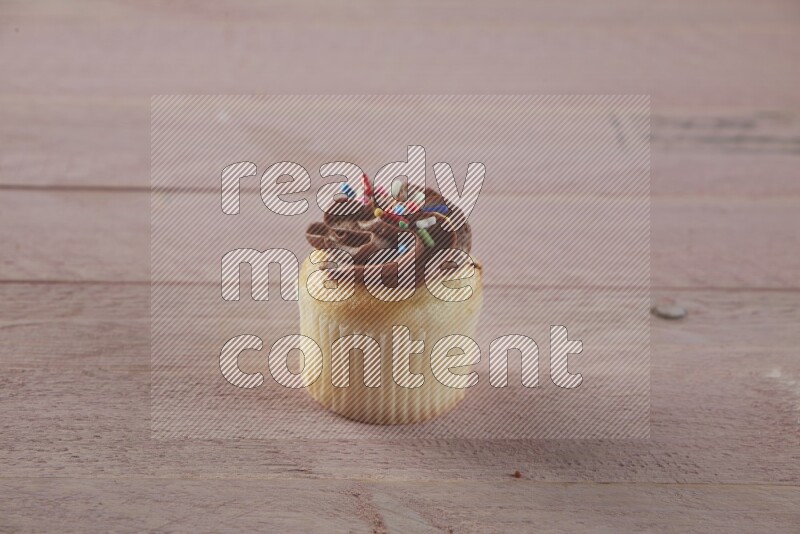 Vanilla mini cupcake topped with chocolate cream