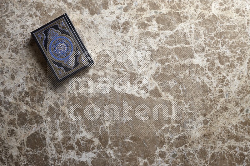 The holy quran on beige marble background