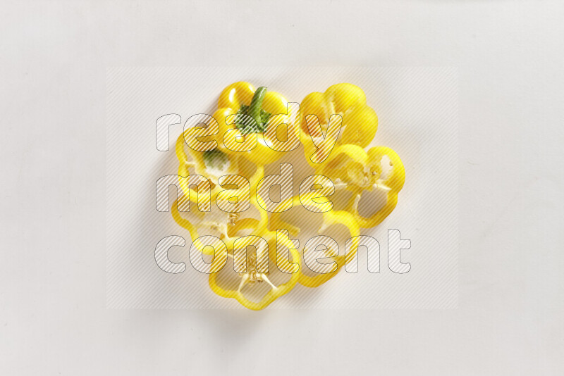 Yellow bell pepper slices on white background