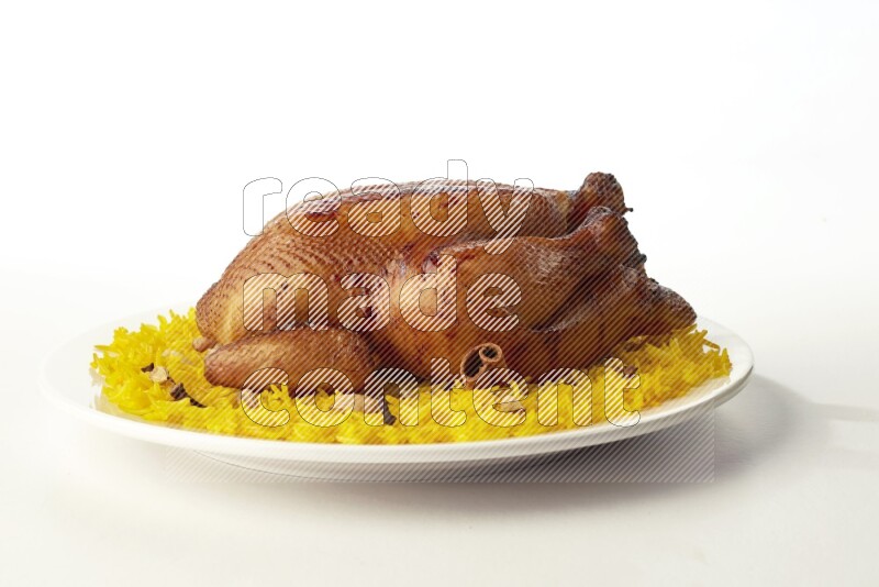 yellow  basmati Rice with  whole roasted chicken on a white rounded plate direct on white background