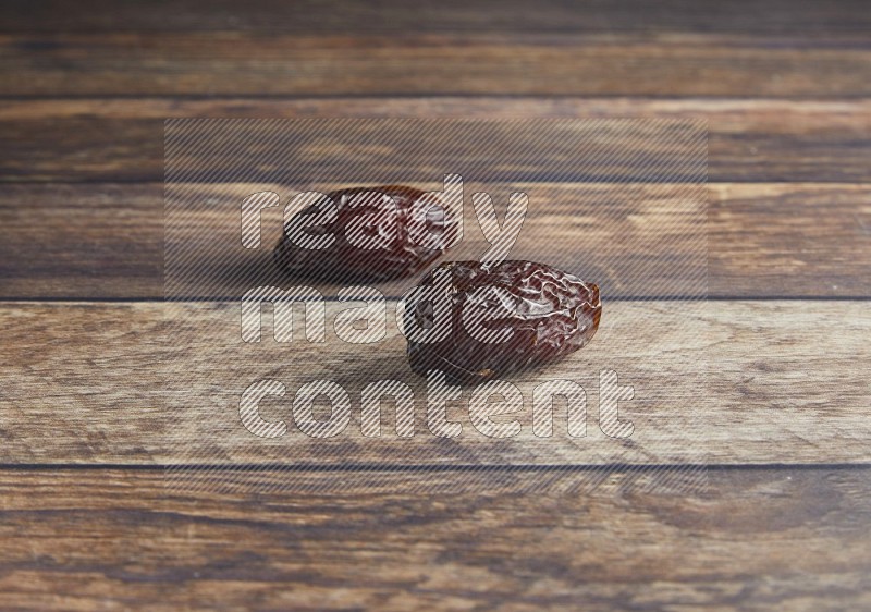 two madjoul dates on a wooden background