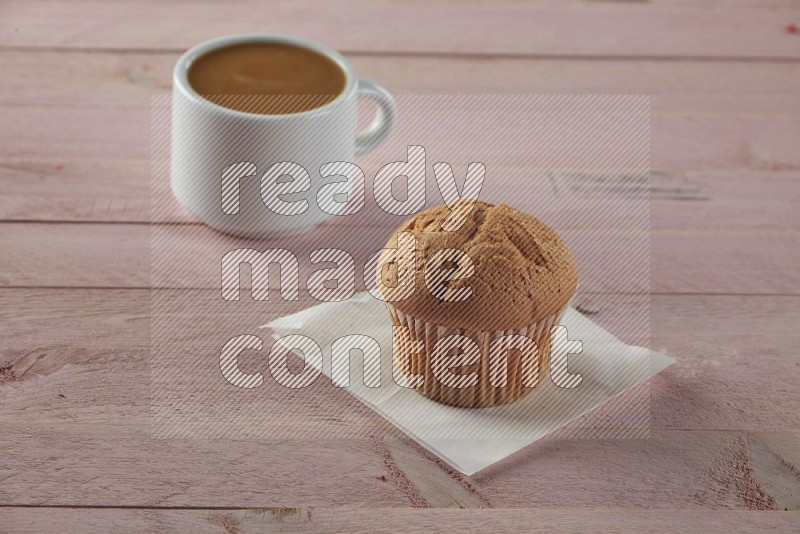 Vanilla cupcake on a wooden pink background