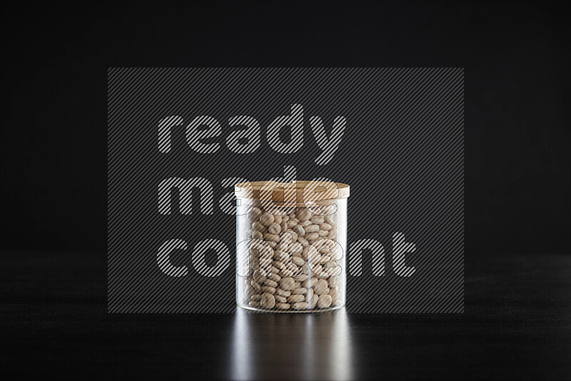 Lupin Beans in a glass jar on black background