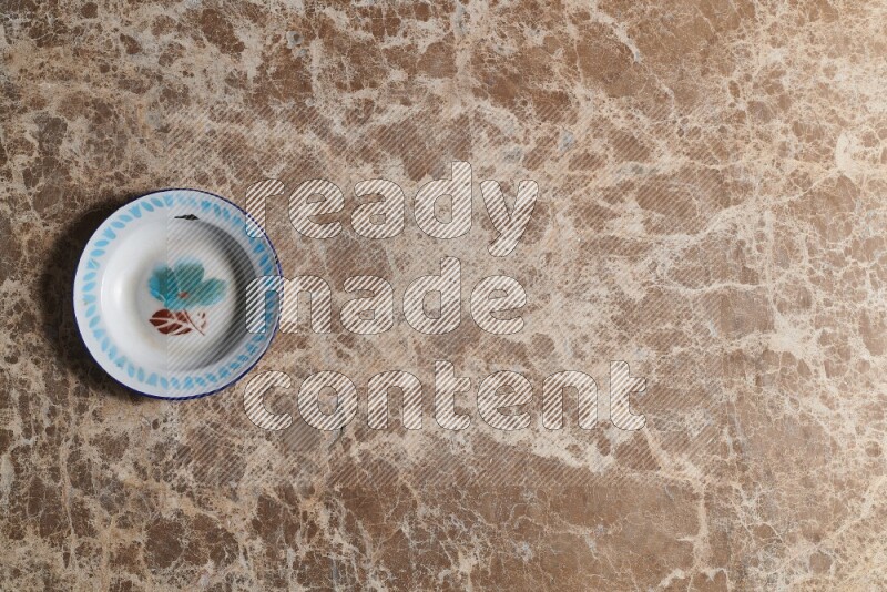 A vintage metal plate on beige marble background