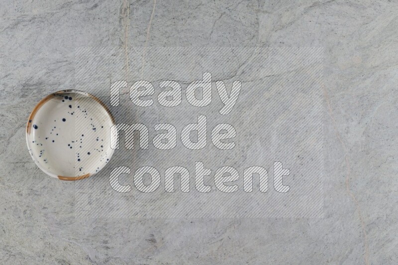 A multicolored pottery Bowl on grey marble background