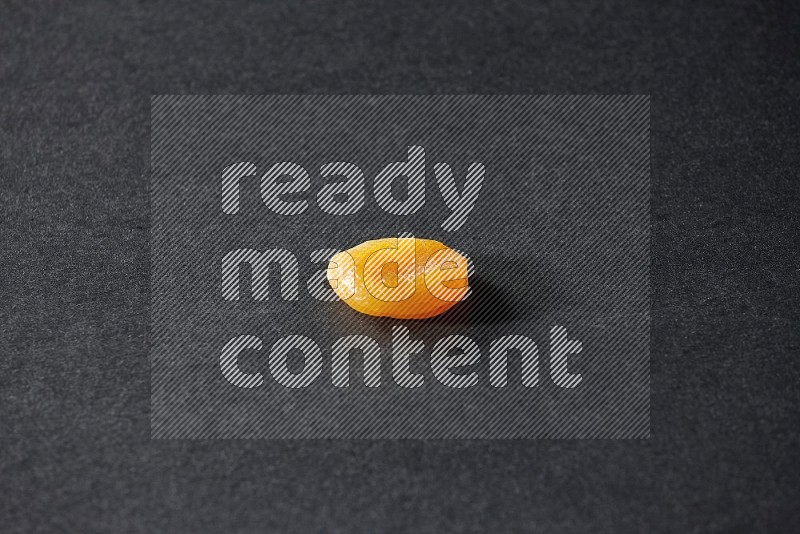 A dried apricot on a black background in different angles