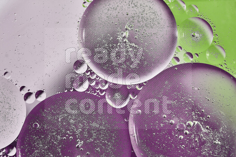 Close-ups of abstract oil bubbles on water surface in shades of purple, green and white